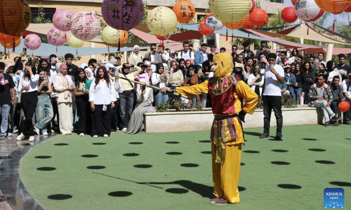 Students watch a Chinese martial arts performance during a Chinese cultural event held at Badr University in Cairo, Cairo Governorate, Egypt, on Oct. 20, 2025. The Badr University in Cairo on Monday held a Chinese Culture Festival at its campus, with exhibition stands of Chinese calligraphy, paper-cutting and handicrafts, as well as activities including Chinese martial arts performance and ethnic costumes show, attracting lots of students and teachers. (Xinhua/Sui Xiankai)