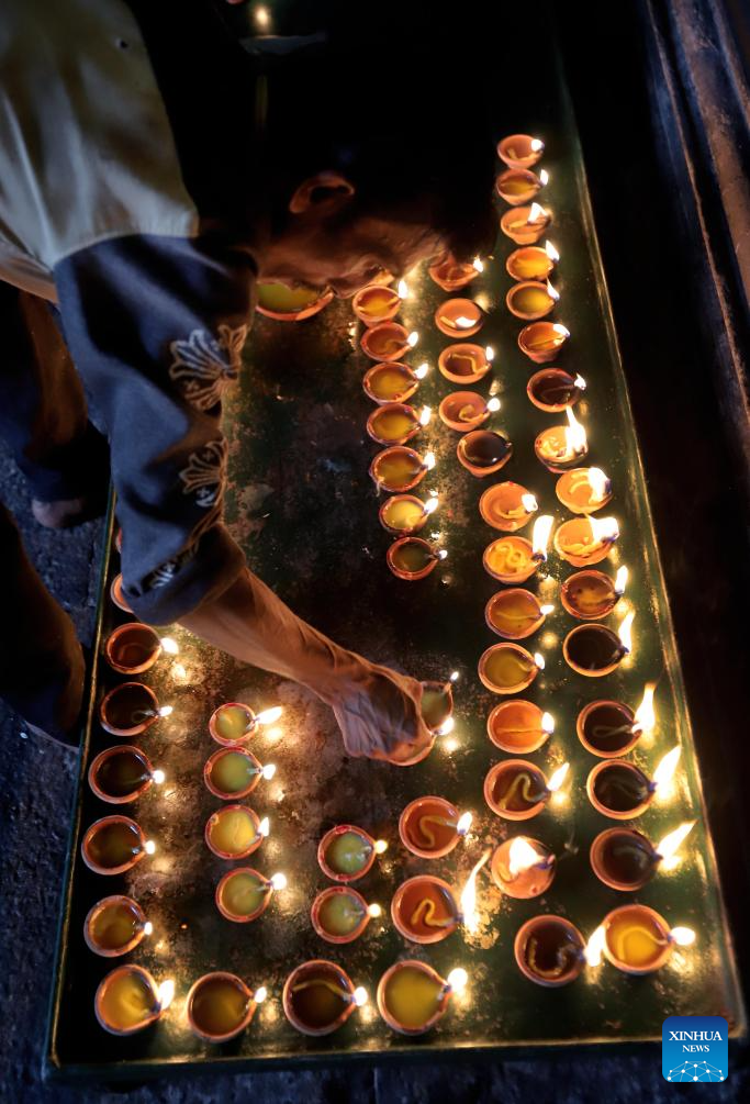 A man lights oil lamps to celebrate Diwali, or the Hindu festival of lights, at a temple in Colombo, Sri Lanka, on Oct. 20, 2025. (Photo by Ajith Perera/Xinhua)