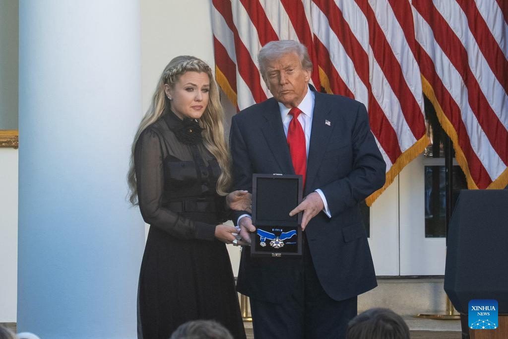 U.S. President Donald Trump (R) presents the Presidential Medal of Freedom to Erika Kirk during a ceremony to posthumously award the medal to Charlie Kirk, in the Rose Garden of the White House, in Washington, D.C., the United States, Oct. 14, 2025. (Xinhua/Hu Yousong)