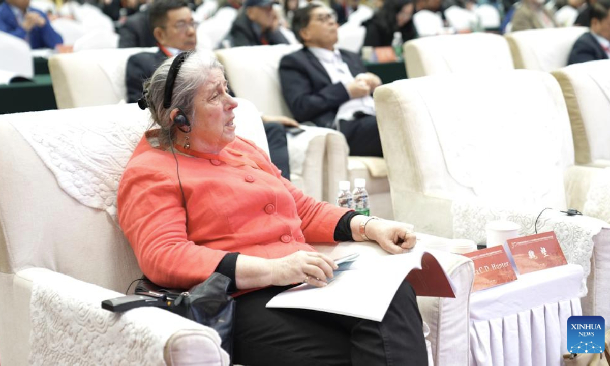 Erica Hunter, a scholar from the University of Cambridge in the UK, listens to a keynote presentation during the Seventh International Symposium of Turfan Studies in Turpan, northwest China's Xinjiang Uygur Autonomous Region, on Oct. 18, 2025. From Oct. 18 to 20, nearly 200 experts and scholars from over 70 universities and research institutes across 16 countries and regions -- including Germany, the United Kingdom (UK), the United States and Japan -- gathered in Turpan for the Seventh International Symposium of Turfan Studies. The topics ranged from heritage conservation to the evolution of Silk Road culture.(Xinhua/Zhou Shengbin)