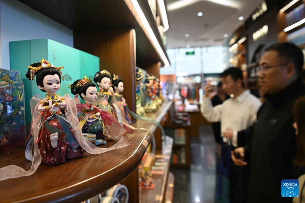 Tourists visit the Dunhuang Book Center in Dunhuang, northwest China's Gansu Province, Oct. 11, 2025. In recent years, Dunhuang has advanced the development of immersive cultural and tourism experience projects. By renovating unused buildings, new cultural landmarks centered on Dunhuang culture have been created, including the Dunhuang Book Center, Dunhuang Press, and Dunhuang Unbounded art gallery. These cultural attractions combining cultural consumption, art exhibitions, interactive experiences, and social activities attract a large number of visitors. (Photo: Xinhua)