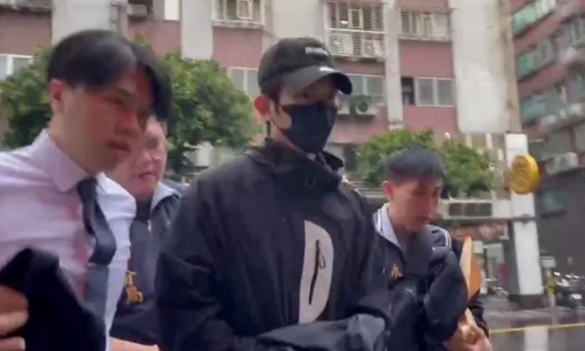 Hsiu Chieh-kai is taken back to the police station on October 21, 2025. Photo: Screenshot from media report