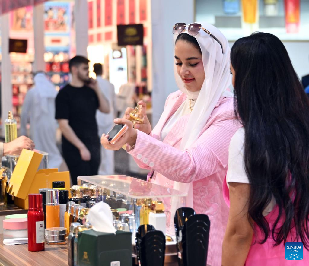 A woman tries perfumes during the Perfume Expo in Hawalli Governorate, Kuwait, Oct. 21, 2025. A Perfume Expo kicked off here in Kuwait on Tuesday and will last until Nov.1 with the participation of more than 400 companies from Kuwait, Saudi Arabia, Oman, Bahrain, Qatar and the Emirates in this field. (Photo by Asad/Xinhua)