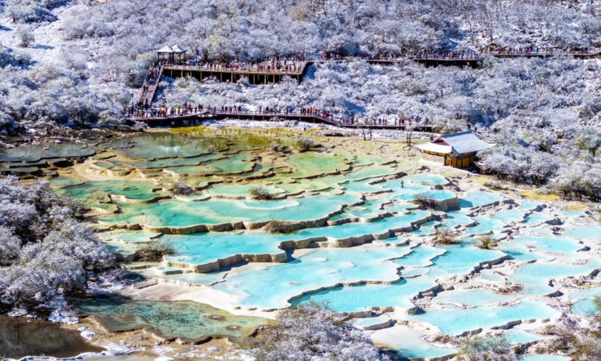 An aerial drone photo taken on Oct. 21, 2025 shows a view of a colorful pond cluster after snow at the Huanglong scenic area in Aba Tibetan and Qiang Autonomous Prefecture, southwest China's Sichuan Province.

Huanglong witnessed the first snowfall of this autumn on Tuesday. (Photo by Sun Jiapeng/Xinhua)