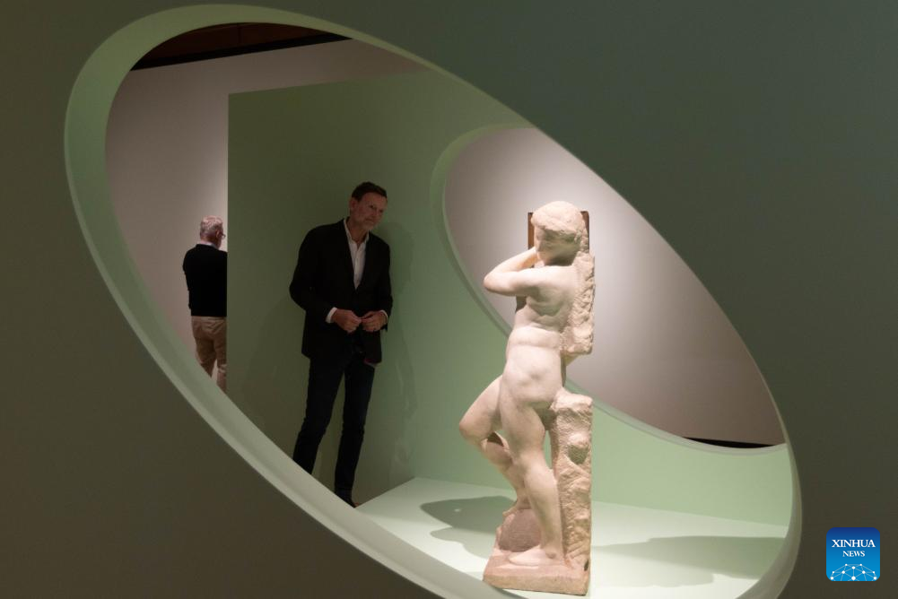 A visitor views a sculpture by Michelangelo during the media preview of the exhibition Michelangelo's Men at the Teylers Museum in Haarlem, the Netherlands, Oct. 13, 2025. The exhibition, which will be open to the public on Wednesday, showcases the works of Italian artist Michelangelo in celebration of his 550th birth anniversary. The exhibition will last until Jan. 25, 2026. (Photo by Sylvia Lederer/Xinhua)