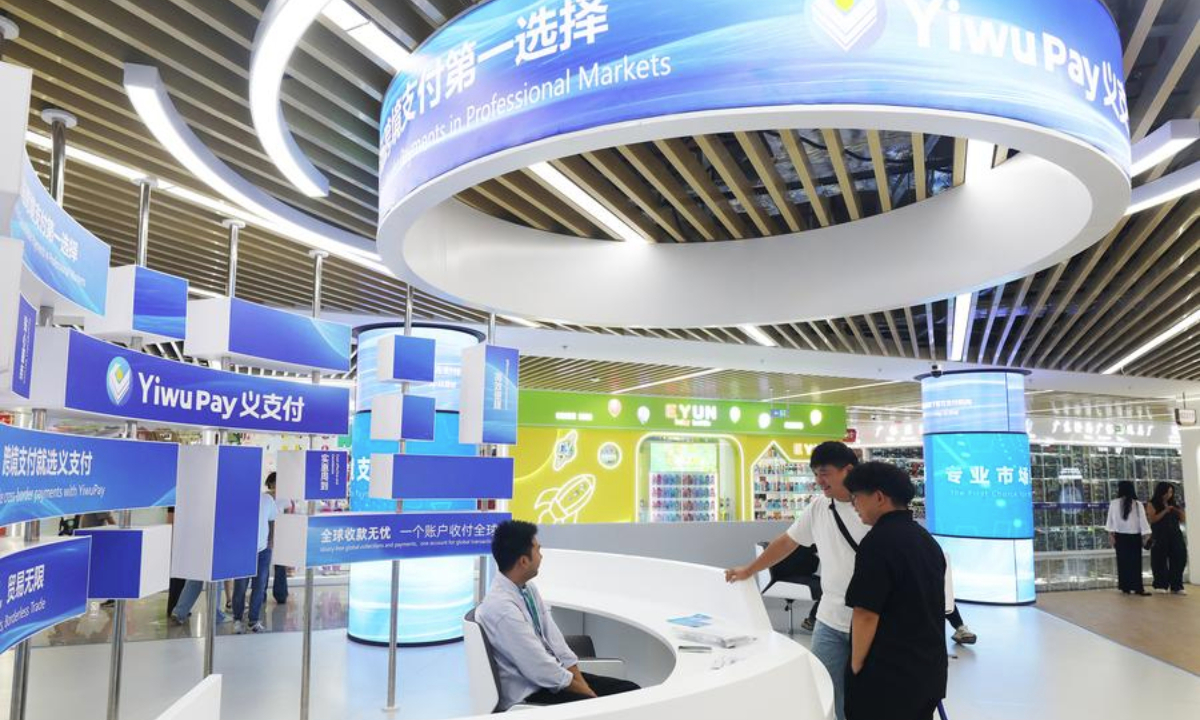 Merchants learn about the Yiwu Pay platform at the Global Digital Trade Center in Yiwu, east China's Zhejiang Province, Oct. 14, 2025. (Photo by Gong Xianming/Xinhua)