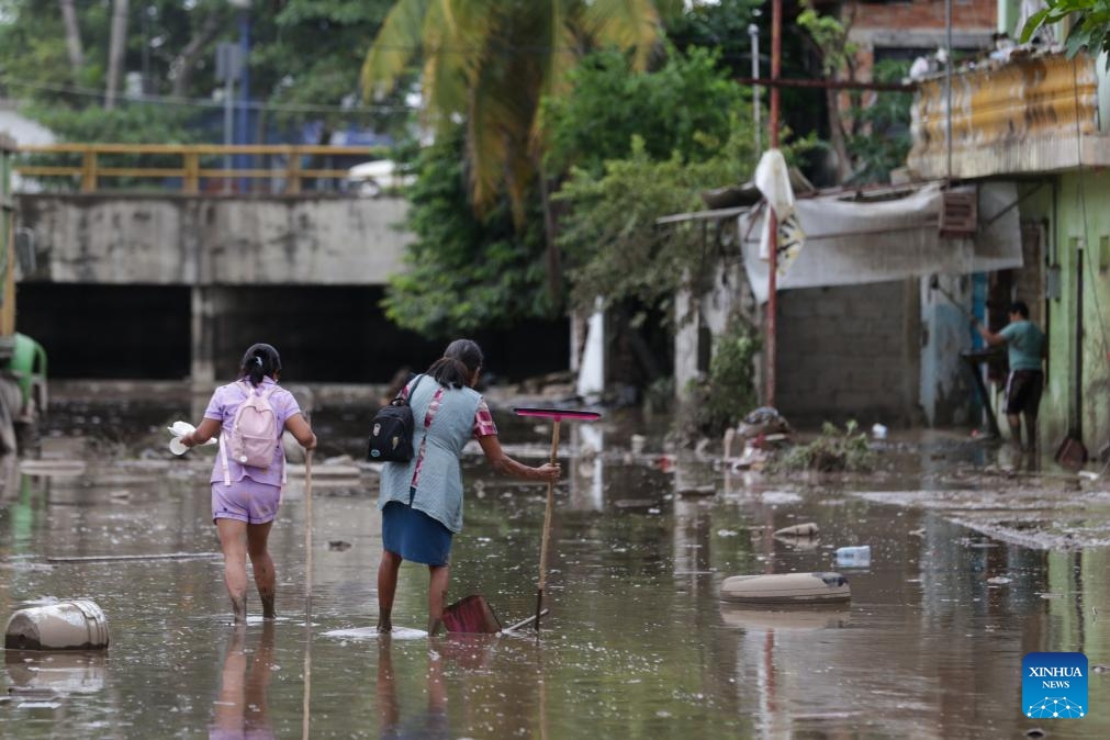 People wade through a flooded street in the city of Poza Rica, Veracruz state, Mexico, Oct. 11, 2025. At least 41 people have been killed as torrential rains and landslides battered Mexico in recent days. (Photo: Xinhua)