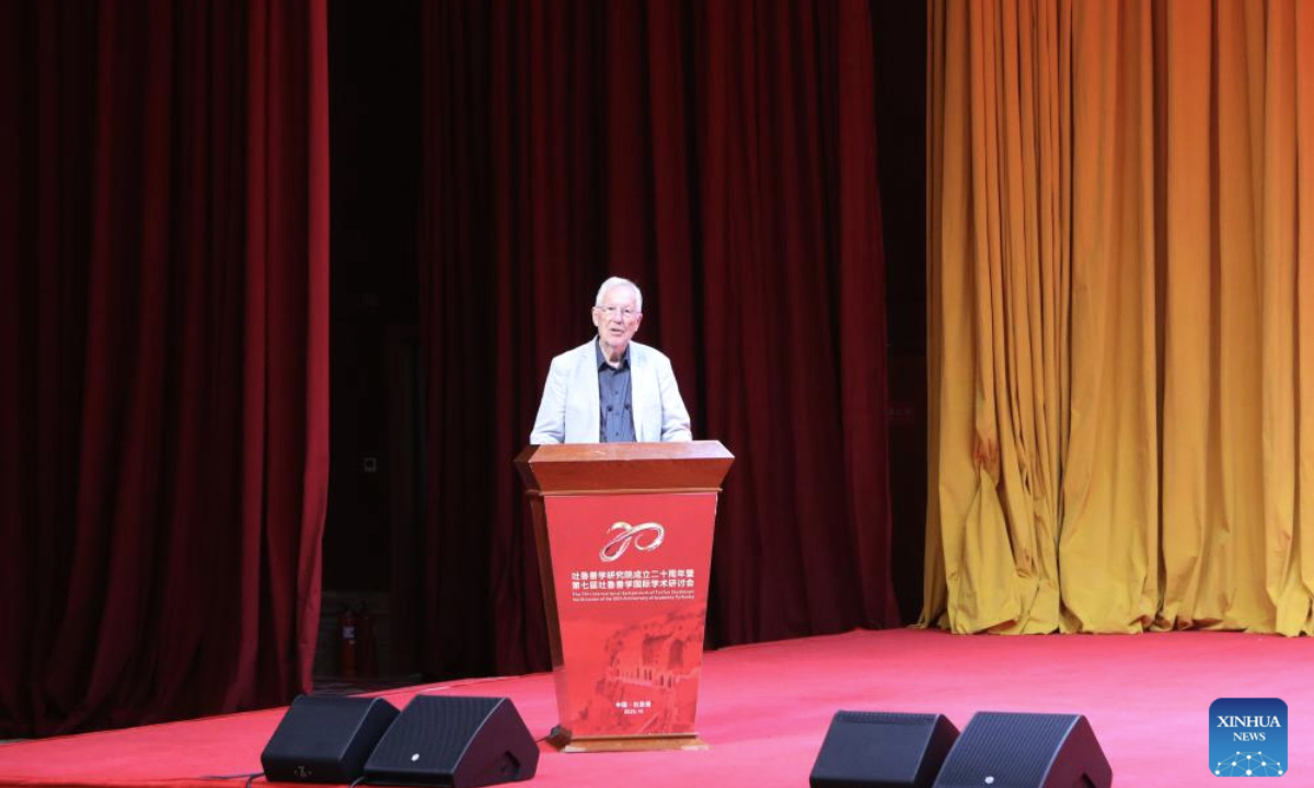 Peter Zieme, a professor at the Berlin-Brandenburg Academy of Sciences and Humanities in Germany, delivers a keynote presentation during the Seventh International Symposium of Turfan Studies in Turpan, northwest China's Xinjiang Uygur Autonomous Region, on Oct. 18, 2025. From Oct. 18 to 20, nearly 200 experts and scholars from over 70 universities and research institutes across 16 countries and regions -- including Germany, the United Kingdom (UK), the United States and Japan -- gathered in Turpan for the Seventh International Symposium of Turfan Studies. The topics ranged from heritage conservation to the evolution of Silk Road culture.(Photo by Liu Ziang/Xinhua)