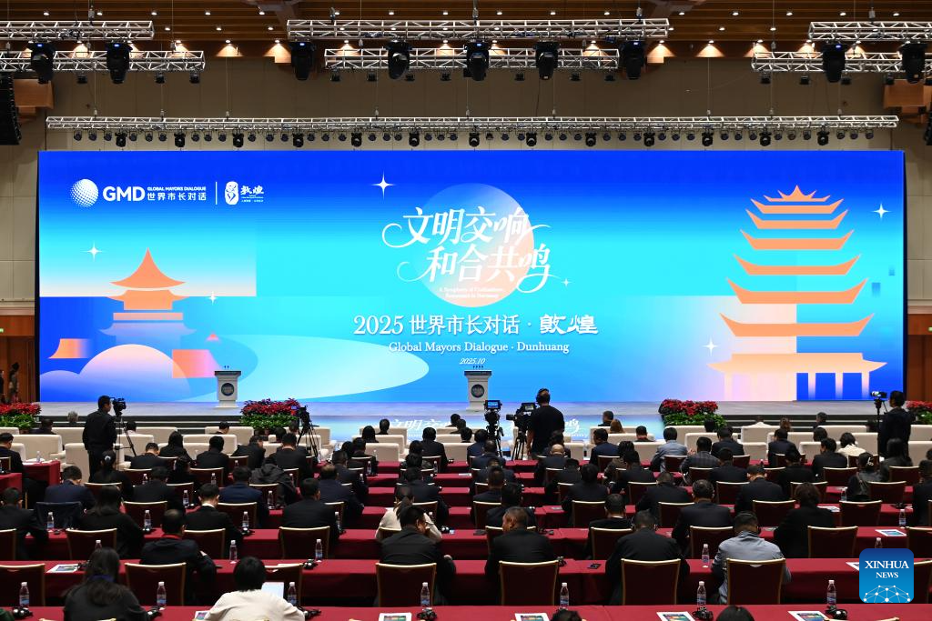 The opening ceremony of the Global Mayors Dialogue Dunhuang is held in Dunhuang, northwest China's Gansu Province, Oct. 13, 2025. A forum bringing together mayors or their representatives, diplomats and scholars from 10 countries opened on Monday in Dunhuang, a city along the ancient Silk Road in northwest China's Gansu Province. The forum aims to discuss opportunities and challenges in cultural urban governance. Themed A Symphony of Civilizations, Resonance in Harmony, the Global Mayors Dialogue Dunhuang focuses on practical governance issues, including leveraging cultural resources, environmental protection, green development and smart city construction. (Xinhua/Fan Peishen)