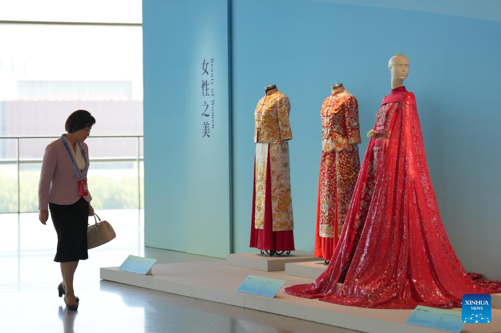 A woman visits Heritage Blossoms, Women Shine, a special exhibition celebrating the Global Leaders' Meeting on Women in Beijing, capital of China, Oct. 13, 2025. The Global Leaders' Meeting on Women was held in Beijing on Monday. (Xinhua/Xu Bingjie)