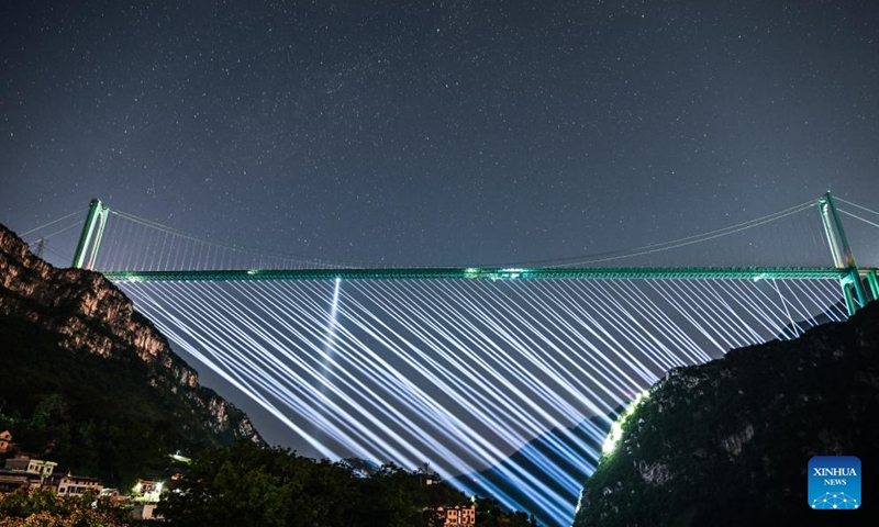 This photo taken on Oct. 11, 2025 shows the Huajiang Grand Canyon Bridge under the starry sky in southwest China's Guizhou Province. The Huajiang Grand Canyon Bridge, soaring 625 meters above the Beipan River in Guizhou's mountainous terrain, is the world's tallest bridge. With a main span of 1,420 meters, the project has become the world's longest-span steel truss girder suspension bridge in mountainous terrain, according to Guizhou provincial authorities. (Photo: Xinhua)