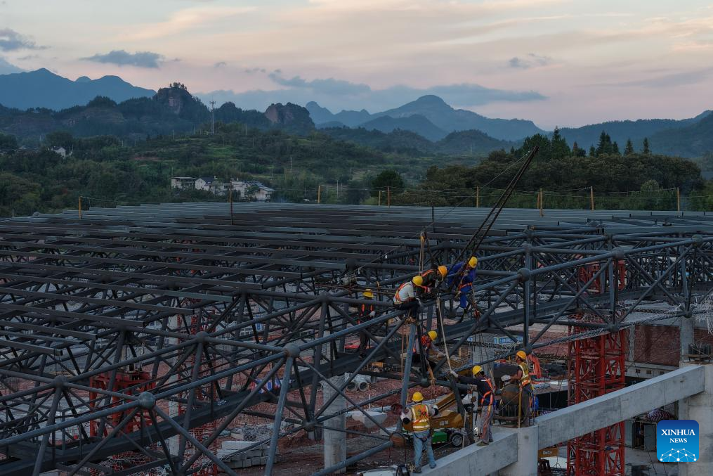 An aerial drone photo taken on Oct. 14, 2025 shows workers working at the construction site of a station of the Quzhou-Lishui railway in Lishui, east China's Zhejiang Province. The 160-km rail line will further improve the regional railway network, effectively promote tourism development in southwestern Zhejiang. (Xinhua/Huang Zongzhi)