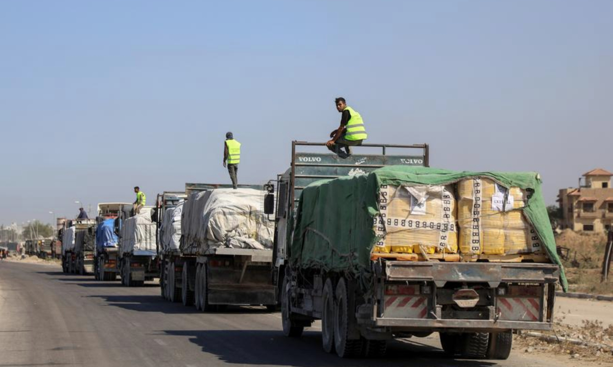 Trucks carrying aid supplies are seen in Deir al-Balah, central Gaza Strip, on Oct. 16, 2025. (Photo by Rizek Abdeljawad/Xinhua)