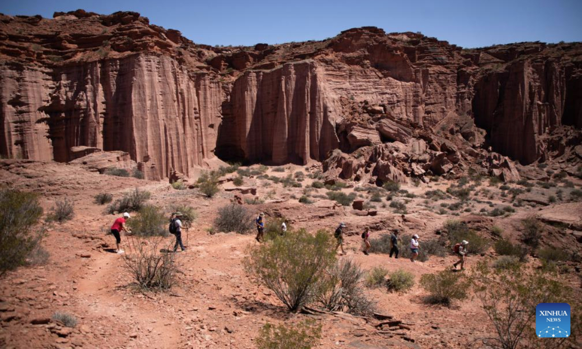 Visitors view the rock formations of the Talampaya Canyon at the Talampaya National Park in La Rioja Province, Argentina, on Oct. 11, 2025. The Talampaya National Park, covering an area of 215,000 hectares, is inscribed on the UNESCO World Heritage List. (Photo by Martin Zabala/Xinhua)