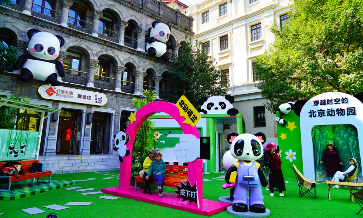 Visitors take photos at a panda-themed park in Beijing on October 13, 2025. The venue, co-created by the Beijing Zoo,  is filled with delightful panda-themed installations, including video of star panda Meng Lan of the zoo, alongside a range of panda merchandise and interactive photo spots, drawing crowds of visitors to this 