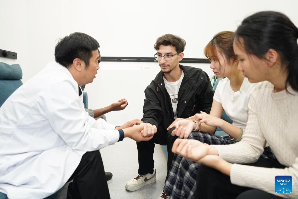 Pan Yinxing (1st, L), a lecturer from Anhui University of Chinese Medicine, teaches international students to take the patient's pulse at Anhui University of Chinese Medicine in Hefei, east China's Anhui Province, Oct. 16, 2025. More than 140 students from around the world are systematically learning traditional Chinese medicine (TCM) theory at the School of Humanities and International Education Exchange at Anhui University of Chinese Medicine. The school provides bilingual courses combining TCM theories and clinical practice for international students. Meanwhile, various cultural activities have been organized for them to enhance their understanding of TCM.

So far, some graduates have returned to their home countries and are working in local healthcare services. (Xinhua/Du Yu)