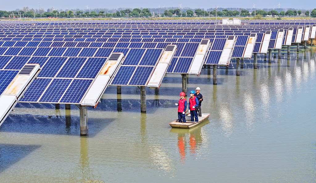 Workers monitor the operation of power generation facilities at the 40-megawatt fishery-photovoltaic integrated power station in Muma Lake, Qinlan Town of Tianchang City, East China's Anhui Province, on October 14, 2025. The model has improved land use efficiency, promoted clean low-carbon transformation of energy, benefited villagers and promoted the local economy and environment. Photo: VCG
