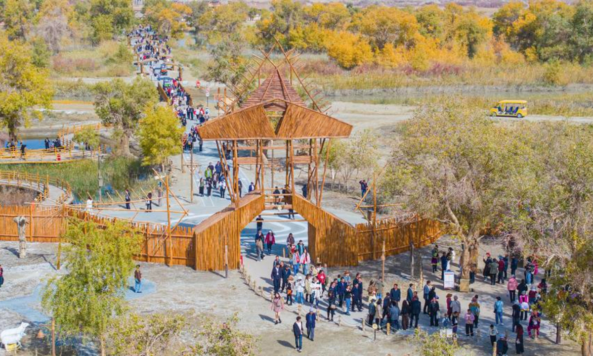 A drone photo taken on Oct. 18, 2025 shows tourists visiting a scenic spot in Yuli County, Mongolian Autonomous Prefecture of Bayingolin, northwest China's Xinjiang Uygur Autonomous Region. (Photo by Wang Zhipeng/Xinhua)