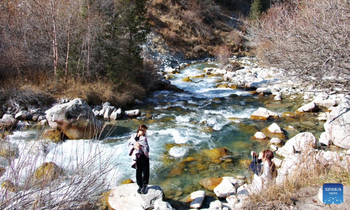 Tourists take photos in the Ala-Archa National Park, some 30 kilometers away from Bishkek, Kyrgyzstan, Oct. 19, 2025. (Photo by Liu Xiaowan/Xinhua)