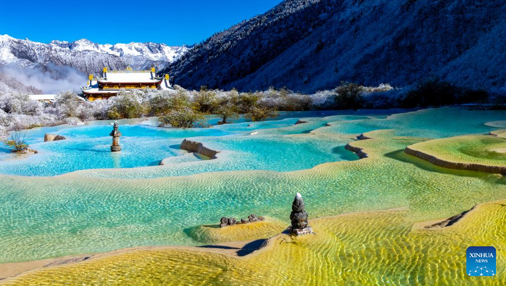 A drone photo taken on Oct. 21, 2025 shows a view of a colorful pond cluster after snow at the Huanglong scenic area in Aba Tibetan and Qiang Autonomous Prefecture, southwest China's Sichuan Province.

Huanglong witnessed the first snowfall of this autumn on Tuesday. (Photo by Sun Jiapeng/Xinhua)