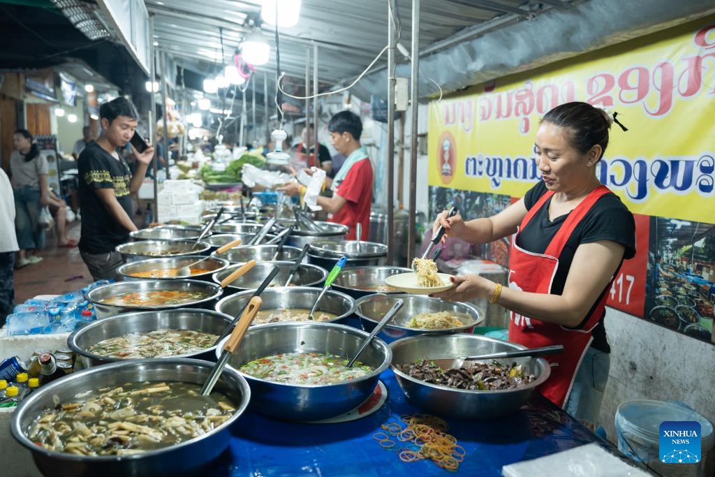 A woman prepares food at a booth in Luang Prabang, Laos, Oct. 10, 2025. According to the World Bank statistics, the female population in Laos accounted for 49.8 percent of the country's total population in 2024. (Photo: Xinhua)