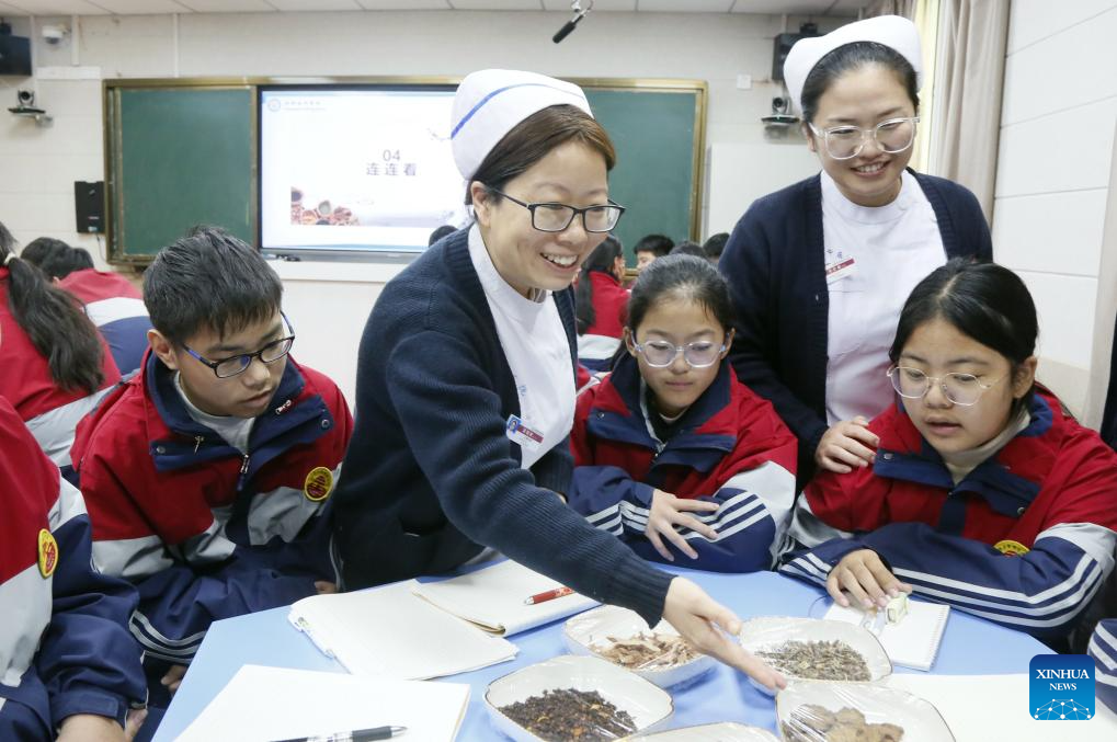 Medical staff explain the types and functions of traditional Chinese medicine (TCM) to the students of a middle school in Ruyang County of Luoyang City, central China's Henan Province, Oct. 22, 2025. Lessons on TCM were introduced in various ways across the country to welcome the annual World Traditional Medicine Day which falls on Oct. 22. (Photo by Kang Hongjun/Xinhua)