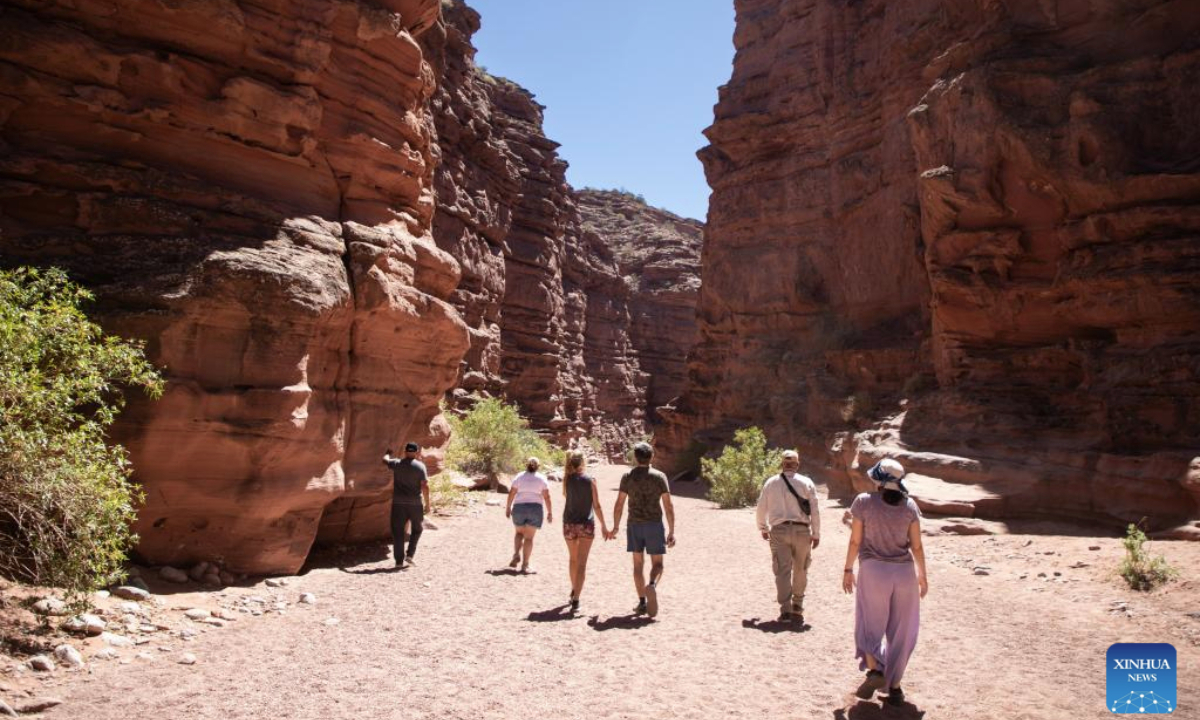 Visitors view the rock formations of the Talampaya Canyon at the Talampaya National Park in La Rioja Province, Argentina, on Oct. 11, 2025. The Talampaya National Park, covering an area of 215,000 hectares, is inscribed on the UNESCO World Heritage List. (Photo by Martin Zabala/Xinhua)