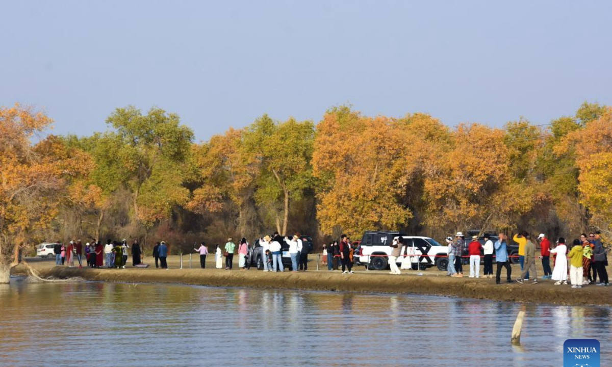 Tourists enjoy the autumn scenery of desert poplar (populus euphratica) forest in Xayar County, northwest China's Xinjiang Uygur Autonomous Region, Oct. 22, 2025. (Xinhua/Gu Yu)