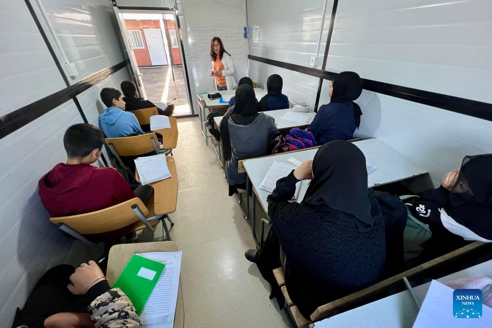 Students attend their first day of classes in prefabricated rooms at a temporary school in Meiss El Jabal, southern Lebanon, Oct. 20, 2025. The temporary school here was established to replace three schools destroyed by Israeli strikes last year, allowing students to resume their studies in the new school year. (Photo by Ali Hashisho/Xinhua)