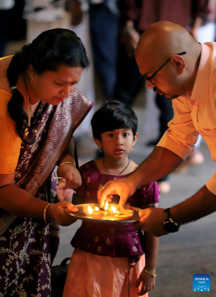 People hold oil lamps to celebrate Diwali, or the Hindu festival of lights, at a temple in Colombo, Sri Lanka, on Oct. 20, 2025. (Photo by Ajith Perera/Xinhua)