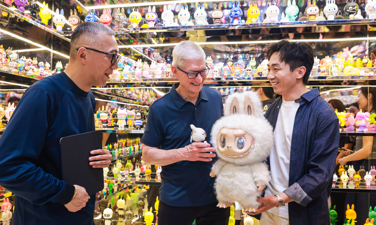 Apple CEO Tim Cook receives a gift — LABUBU, from Wang Ning, the founder and CEO of Pop Mart, during THE MONSTERS exhibition in Shanghai on October 13, 2025. Photo: Courtesy of Pop Mart