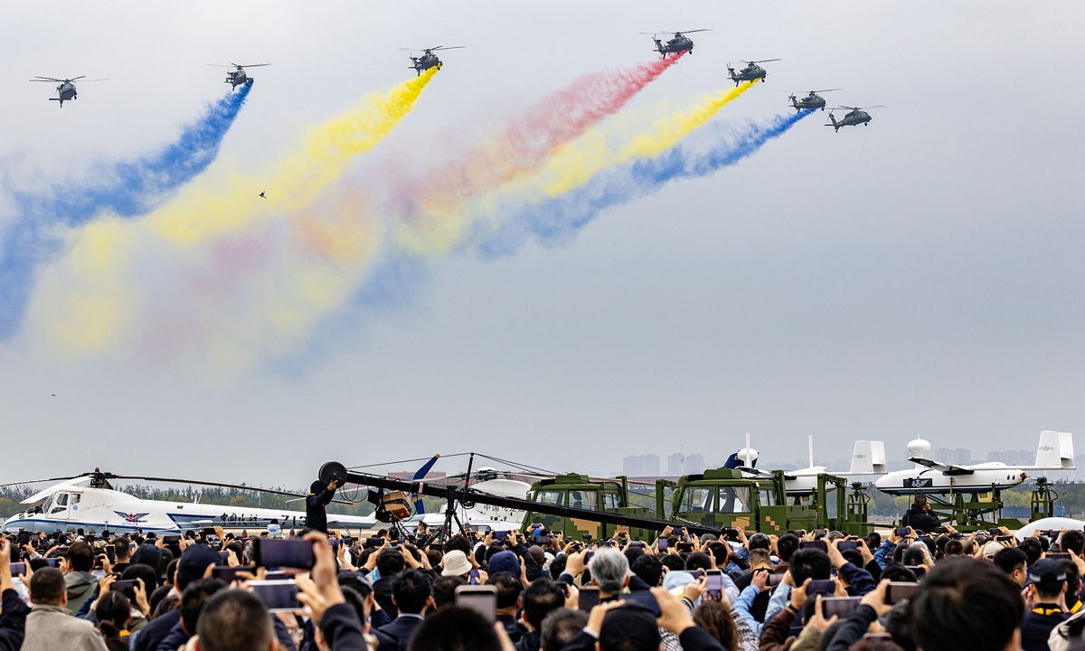 The Chinese PLA Army's Fenglei Thunder Aerobatic Team kicks off the first aerobatic show of the 7th China Helicopter Exposition with a seven-helicopter formation flypast in North China's Tianjin Municipality on October 16, 2025. Photo: VCG