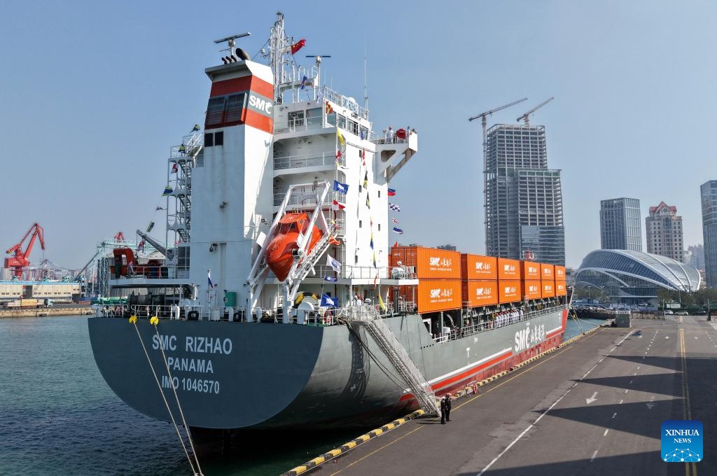 A drone photo taken on Oct. 16, 2025 shows the SMC RIZHAO ship performing the maiden voyage of the Qingdao-Jeju container shipping route berthing at the Qingdao International Cruise Terminal in Qingdao, east China's Shandong Province. A regular direct container shipping route between Qingdao and South Korea's Jeju was launched on Thursday. This express shipping route will operate once a week in its initial stage, significantly enhancing the logistics efficiency between the two places, effectively reducing logistics costs, and further densifying the shipping network of east China's Shandong Province to South Korea. (Xinhua/Li Ziheng)