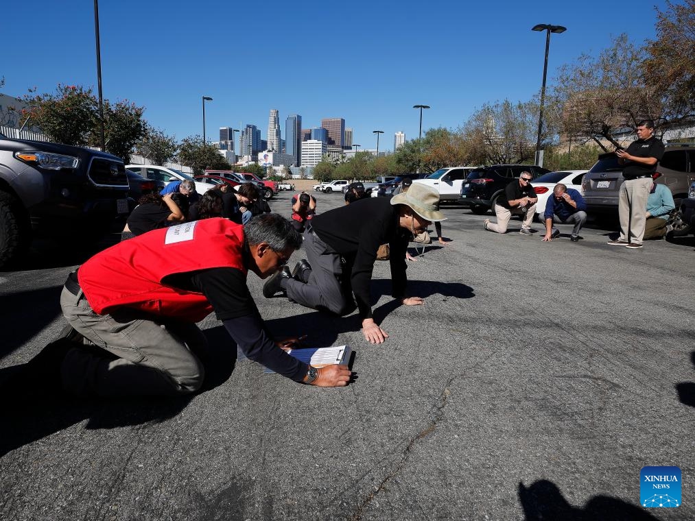 Staff members at the City of Los Angeles Emergency Operations Center follow instructions on how to respond to aftershocks following a major earthquake drill in downtown Los Angeles, California, the United States, Oct. 16, 2025. More than 10 million Californians on Thursday took part in an annual statewide earthquake preparedness drill designed to raise public awareness and strengthen response capabilities for major quakes. (Photo by Qiu Chen/Xinhua)