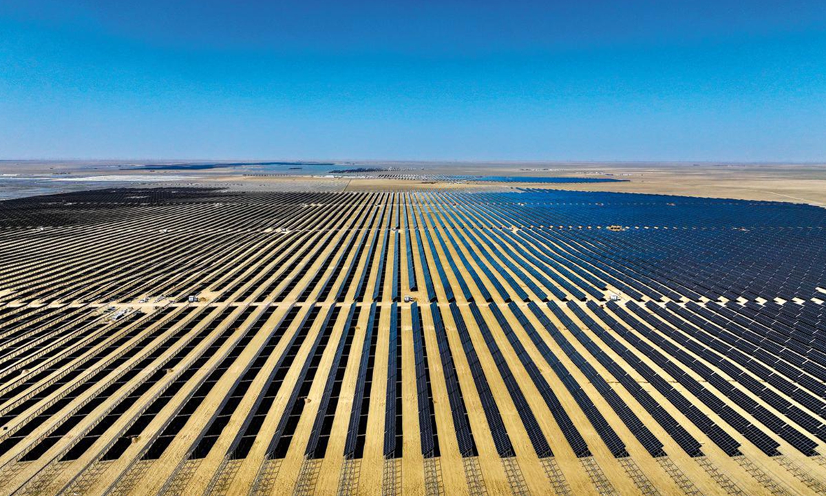 An aerial view of a large photovoltaic plant in China's desert, where vast arrays of solar panels stretch endlessly across the arid landscape Photo: MF