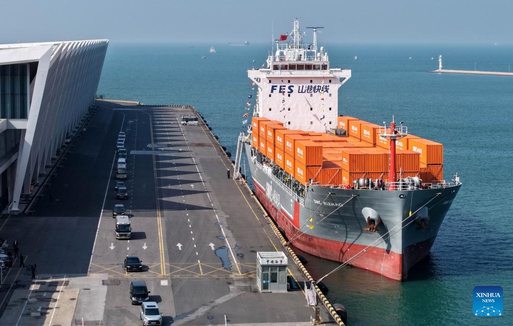 A drone photo taken on Oct. 16, 2025 shows the SMC RIZHAO ship performing the maiden voyage of the Qingdao-Jeju container shipping route berthing at the Qingdao International Cruise Terminal in Qingdao, east China's Shandong Province. A regular direct container shipping route between Qingdao and South Korea's Jeju was launched on Thursday. This express shipping route will operate once a week in its initial stage, significantly enhancing the logistics efficiency between the two places, effectively reducing logistics costs, and further densifying the shipping network of east China's Shandong Province to South Korea. (Xinhua/Li Ziheng)