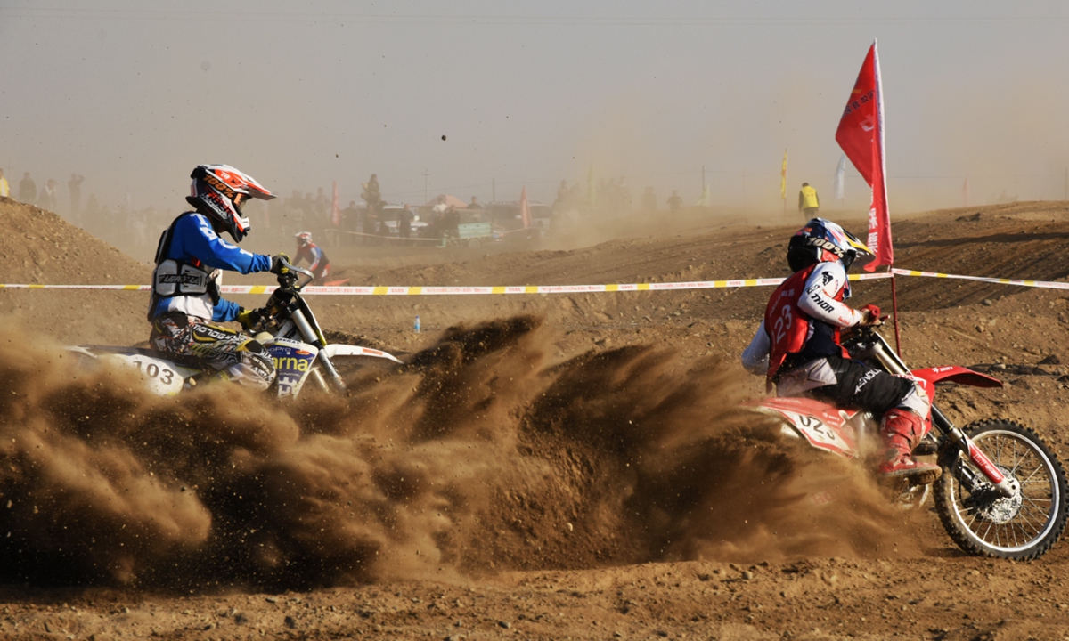 Motorcyclists compete on the opening day of the 2025 Aydingkol Motorcycle Rally on October 19, 2025 in Turpan, Northwest China's Xinjiang Uygur Autonomous Region. A total of 103 motorcyclists representing seven teams from all over the country are participating in the seven-day event, which features five stages and a total distance of approximately 1,800 kilometers. Photo: VCG