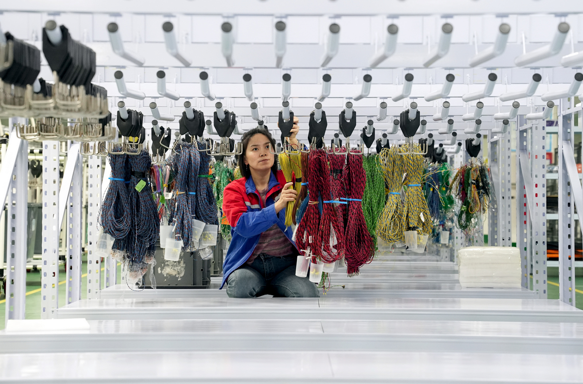 Workers are busy filling orders in an automotive wiring harness production workshop in the economic development zone of Huaying Mountain, Southwest China's Sichuan Province, on October 21, 2025. In recent years, the region has continued to promote small and micro-sized enterprises in the automotive parts industry and actively integrate them into the industrial and supply chains. Photo: VCG