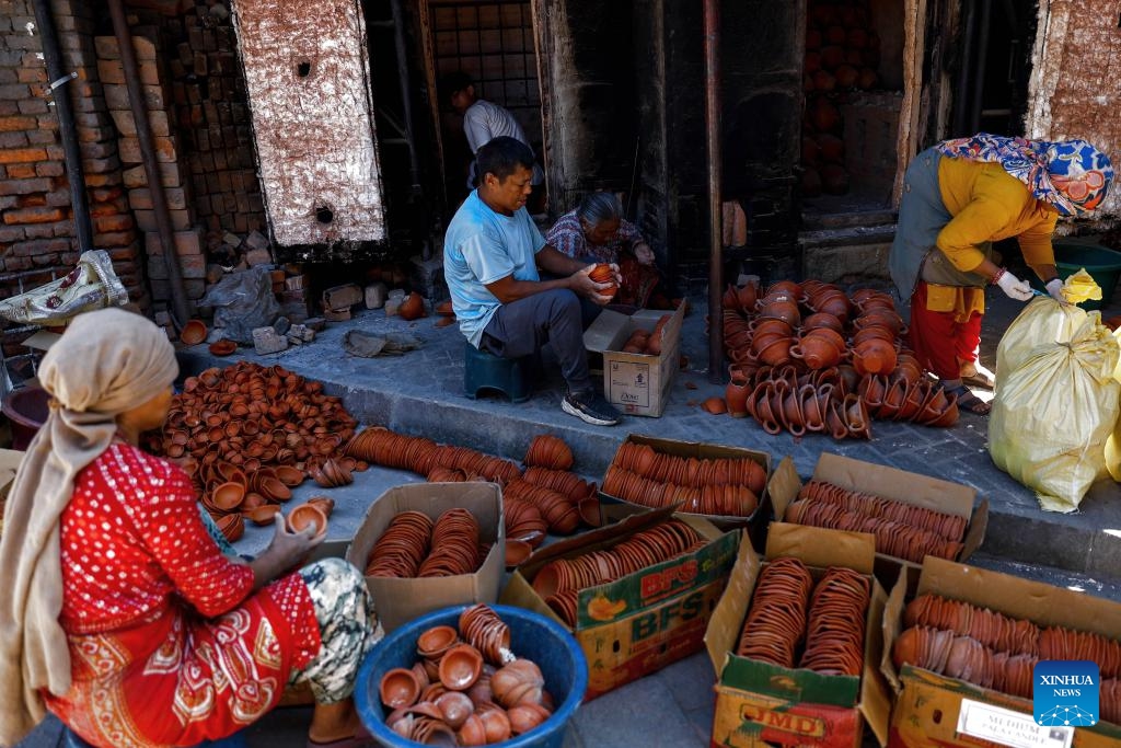 People prepare clay pots for Tihar, a Hindu festival of lights, in Bhaktapur, Nepal, Oct. 19, 2025. These clay pots will be used as oil lamps during Tihar. (Photo: Xinhua)