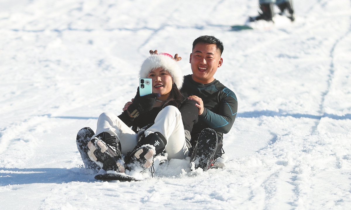 Visitors take selfies at the Yunding ski resort in Hebei Province. 