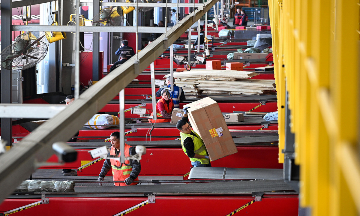 Workers are busy sorting, scanning and dispatching express parcels at a logistics and transshipment center in Suqian, East China's Jiangsu Province, on October 22, 2025, as the annual 
