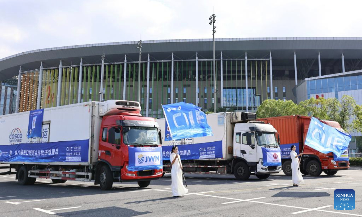 Trucks loaded with exhibits for the upcoming 8th China International Import Expo (CIIE) are seen during a ceremony marking the arrival of exhibits at the National Exhibition and Convention Center (Shanghai), the main venue for the CIIE, in east China's Shanghai, Oct. 23, 2025. The first batch of exhibits for the exhibition areas of Intelligent Industry and Information Technology, Food and Agricultural Products, and Medical Equipment & Healthcare Products of the 8th CIIE arrived at the National Exhibition and Convention Center (Shanghai) on Thursday. (Xinhua/Fang Zhe)