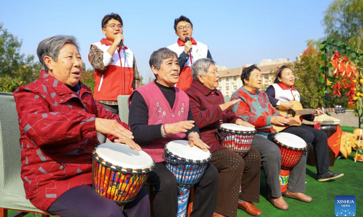 Volunteers perform together with elderly people at a welfare house in Qingdao, east China's Shandong Province, Oct. 28, 2025. A series of activities were held across the country to mark China's Chongyang Festival, which will fall on Oct. 29 this year. Also known as Seniors' Day in China nowadays, it highlights the public's care for elderly people. (Photo by Zhang Ying/Xinhua)