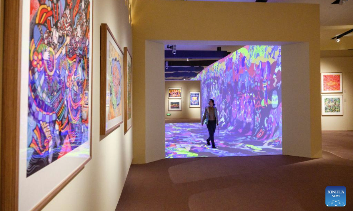 A woman visits the Colorful Brushstrokes upon the Earth: the 2025 Chinese Farmers' Paintings Exhibition at the National Museum of China in Beijing, capital of China, Oct. 28, 2025. The exhibition opened here on Tuesday. (Xinhua/Jin Liangkuai)