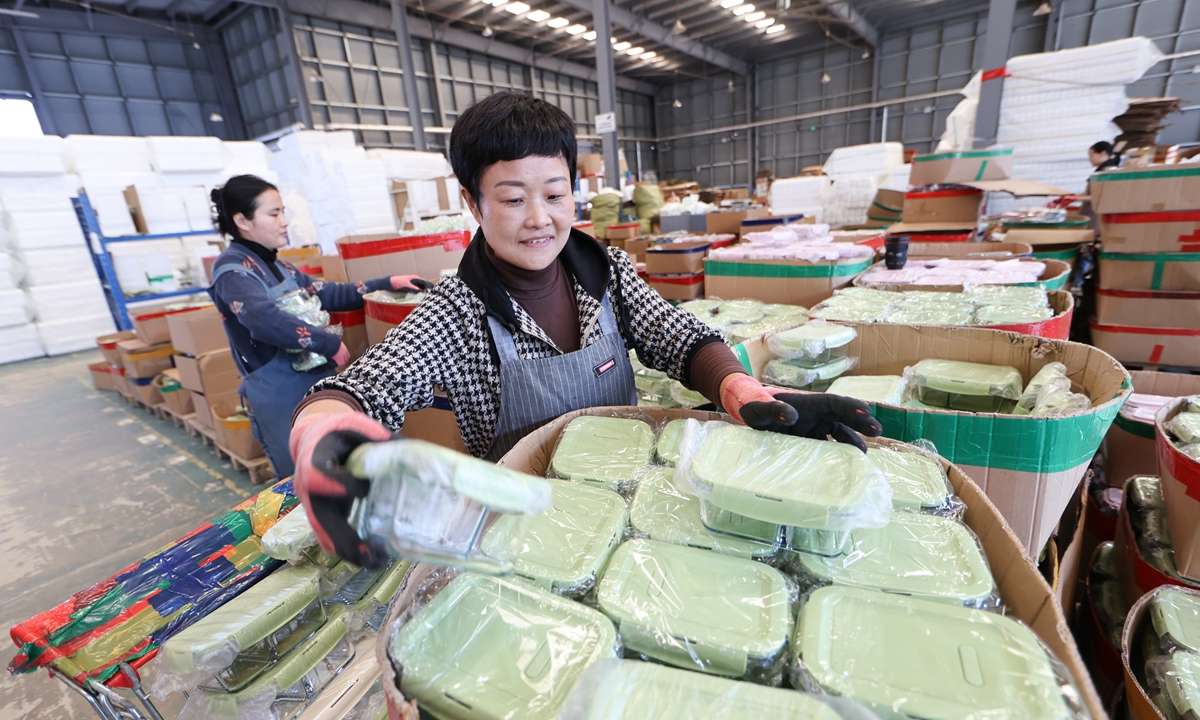 Workers handle goods at an e-commerce logistics warehouse in Ganyu district, Lianyungang, East China's Jiangsu Province, on October 23, 2025. With the 