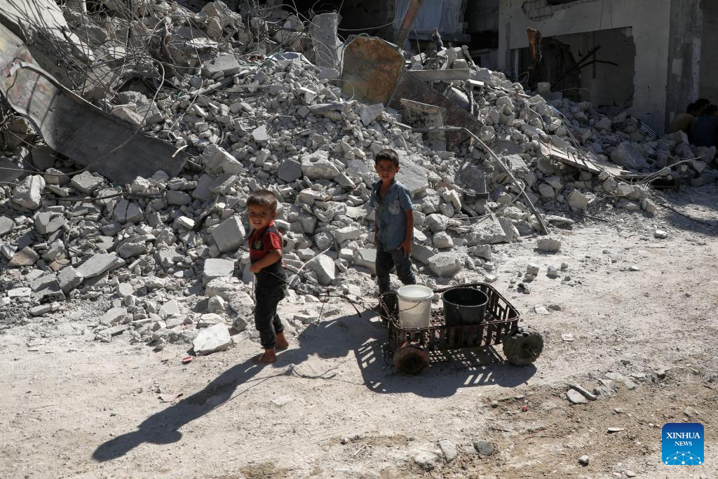 Palestinians fetch water in the Shati refugee camp, west of Gaza City, Oct. 28, 2025. Palestinians may have to wait hours for a small amount of water, which is largely unavailable due to damage to water networks caused by Israeli bombing during the war. (Photo by Rizek Abdeljawad/Xinhua)