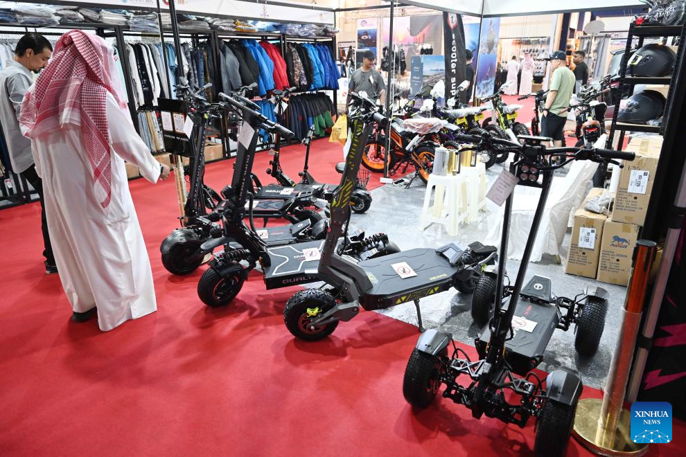 People watch scooters during the Kuwait 2025 International Outdoor Sports and Activities Expo in Hawalli Governorate, Kuwait, Oct. 28, 2025. The 5th edition of the Kuwait 2025 International Outdoor Sports and Activities Expo kicked off here on Tuesday, the 5-day annual event features over 100 participating enterprises. (Photo by Asad/Xinhua)