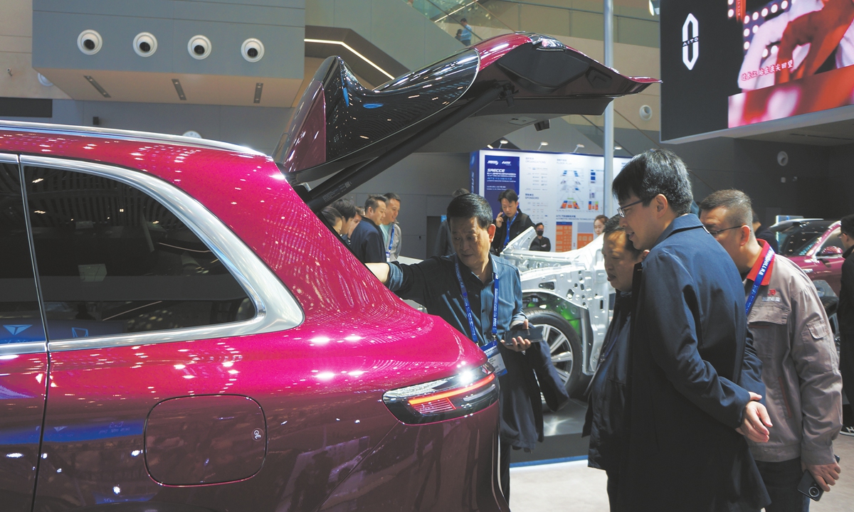 Visitors gather round a car on display at the 32nd China-SAE Congress & Exhibition in Southwest China's Chongqing Municipality on October 22, 2025. Photo: Chu Daye/GT