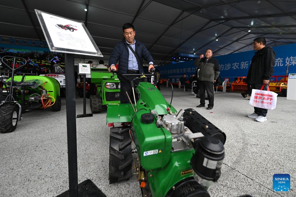 A visitor tries small-scale agricultural machinery at the 32nd China Yangling Agricultural Hi-tech Fair in Yangling, northwest China's Shaanxi Province, Oct. 25, 2025. Featuring innovations in agricultural high-tech achievements, the 32nd China Yangling Agricultural Hi-tech Fair kicked off here on Saturday. (Photo: Xinhua)