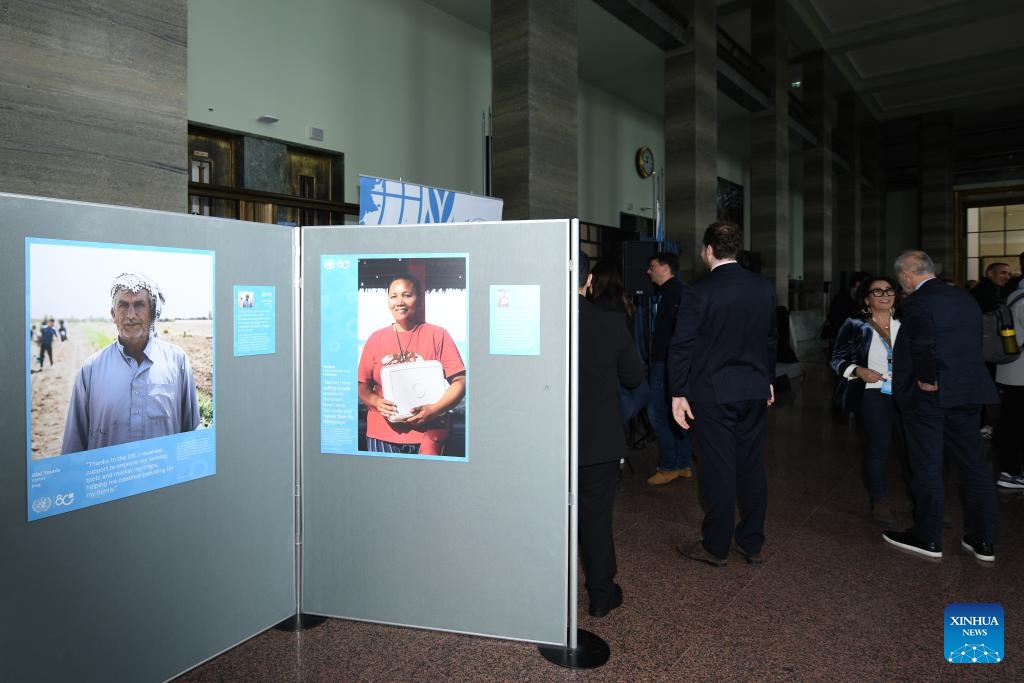 People visit the photo exhibition Shared Lives, Shared Future at the Palais des Nations in Geneva, Switzerland, Oct. 24, 2025. A photo exhibition titled Shared Lives, Shared Future commemorating the 80th anniversary of the United Nations was opened here at the Palais des Nations on Friday, which coincided with United Nations Day. The exhibition presented 27 stories showing the United Nations made a difference in people's daily lives, from advancing peace and security to providing humanitarian aid. (Photo: Xinhua)